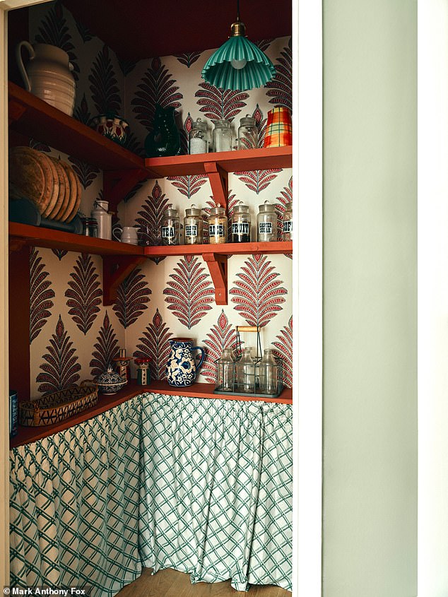 Glass jars inherited from Jules¿s grandmother have pride of place on old scaffolding boards. Coloured in red ochre by Edward Bulmer Natural Paint (edwardbulmerpaint.co.uk), these work perfectly with the leaf motifs ¿ the work of wallpaper and fabric artist Anna French. The under-shelf curtain originated as a vintage pair, bought in a charity shop and repurposed