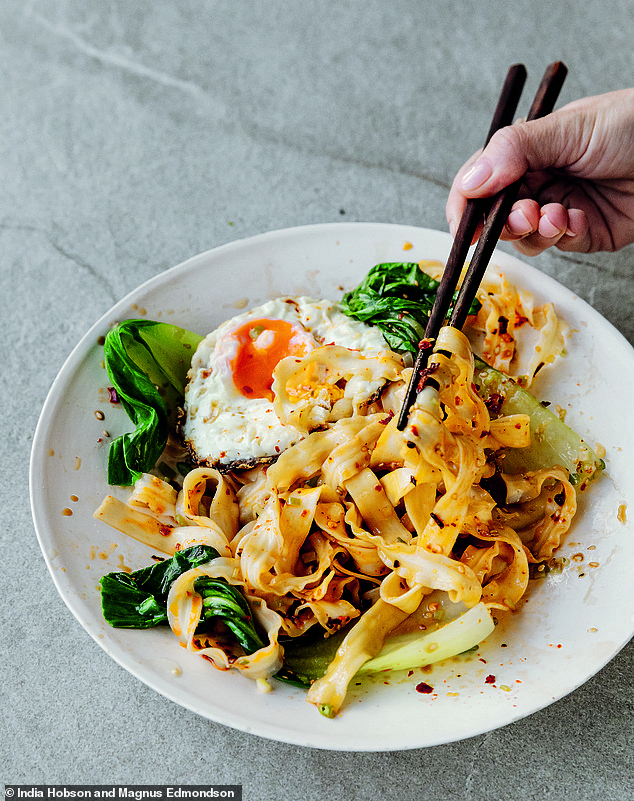 Pouring hot oil over the raw ingredients and noodles creates mini fireworks inside the bowl